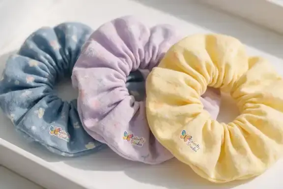 Custom printed scrunchies with logo, made at Colorfly Studio in Dubai