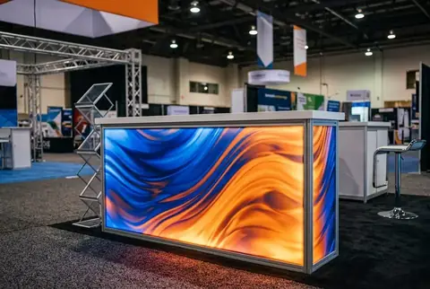 Backlit exhibition counter with printed fabric graphic made in Dubai - Colorfly Studio