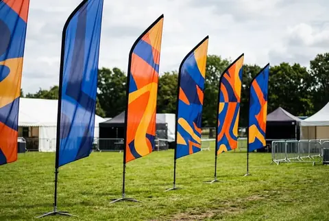 Custom blade flags with cross bases printed in Dubai - Colorfly Studio